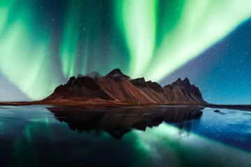 Türaufkleber Nordlichter Aurora borealis Northern lights over famous Stokksnes mountains on Vestrahorn cape. Reflection in the clear water on the epic skies background, Iceland. Landscape photography