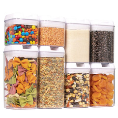 Plastic food containers with dry food isolated on white background