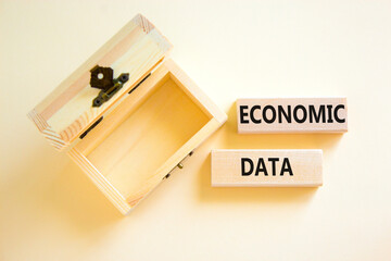 Economic data symbol. Concept words Economic data on wooden block. Beautiful white table white background. Empthy opened wooden chest. Business economic data concept. Copy space.