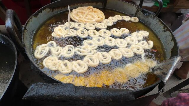 Deep oil jilabi or jilapi  making local street maket. Traditional asian food.