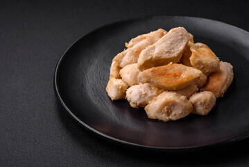 Delicious chicken slices baked with spices and herbs on a round ceramic plate