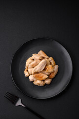Delicious chicken slices baked with spices and herbs on a round ceramic plate