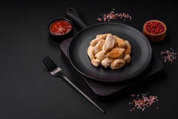 Delicious chicken slices baked with spices and herbs on a round ceramic plate