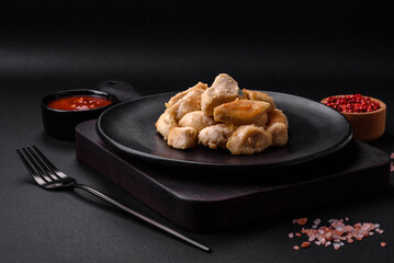 Delicious chicken slices baked with spices and herbs on a round ceramic plate