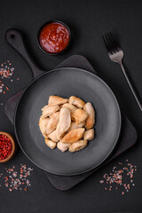 Delicious chicken slices baked with spices and herbs on a round ceramic plate