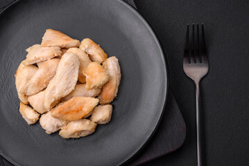 Delicious chicken slices baked with spices and herbs on a round ceramic plate