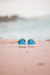 Fototapeta na wymiar baby shoes on the sand