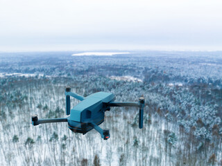 Fototapeta premium Aerial drone view on the background of trees and nature landscape. The concept of flying a drone, taking photos using a drone, aerial filming.