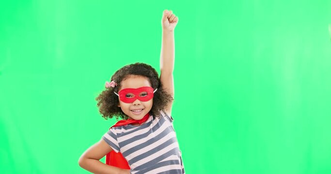 Child, superhero and hand to fly on green screen to stop crime and fight with fantasy or cosplay costume. Girl power, hero and game with smile of strong kid portrait to protect freedom and justice