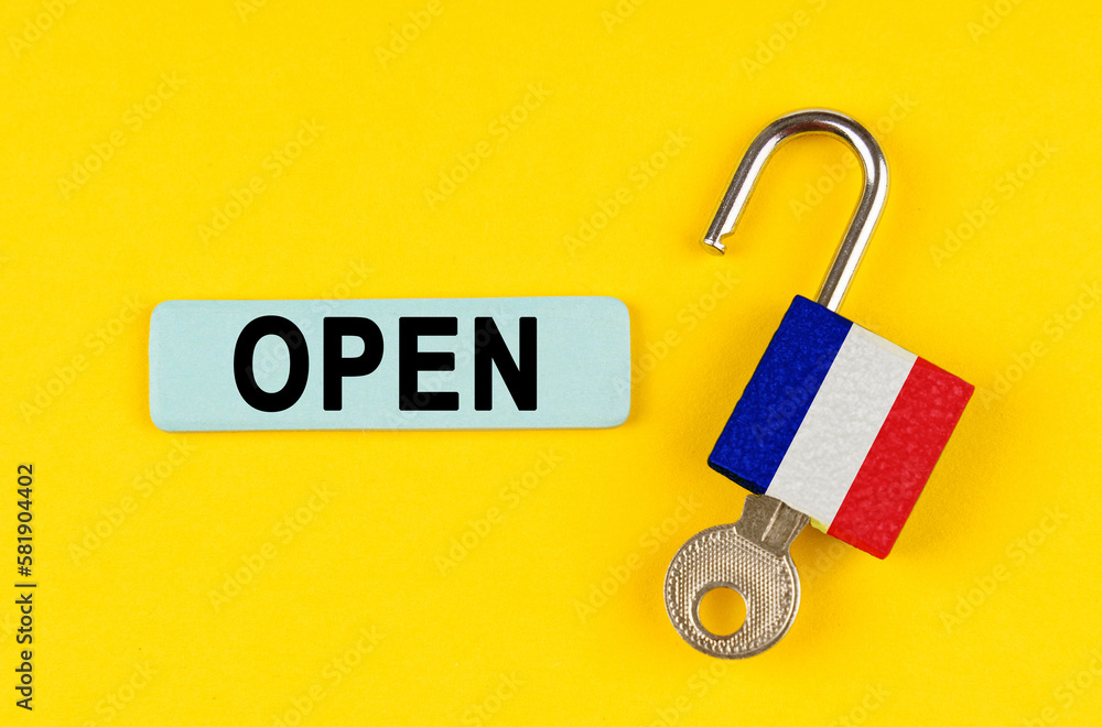 Poster On the yellow surface is an open lock with a key and a sticker with the inscription - open