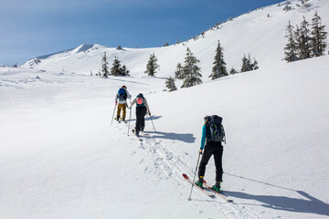The winter mountains provide a challenging but rewarding climb for this group of skiers, who forge...