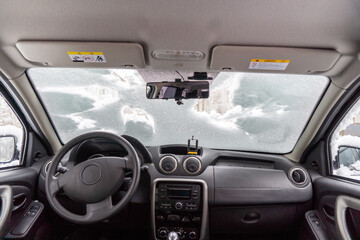 car windshield under a layer of snow, winter frozen car window