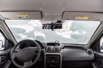 car windshield under a layer of snow, winter frozen car window