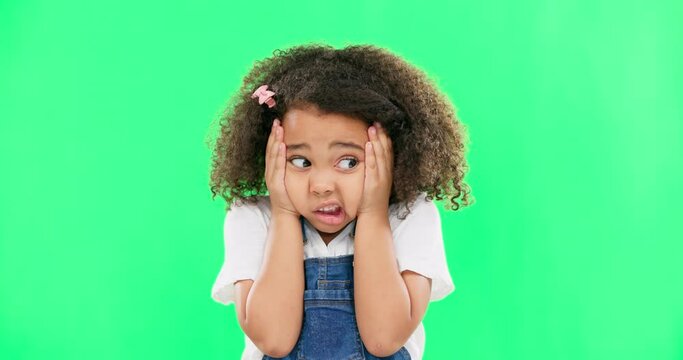 Fear, worried and mistake with a girl on a green screen background in studio feeling nervous or anxious. Portrait, face and panic with a scared little female child looking afraid on chromakey