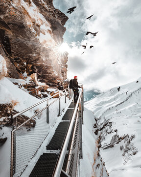 Man Standing on Swiss Mountain Bridge