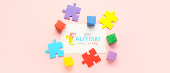 Paper sheet with text WORLD AUTISM AWARENESS DAY, 2 APRIL, puzzle pieces and cubes on pink background