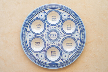 Traditional Seder Plate for Jewish holiday Pesach (Passover). Hebrew words on plate say: 