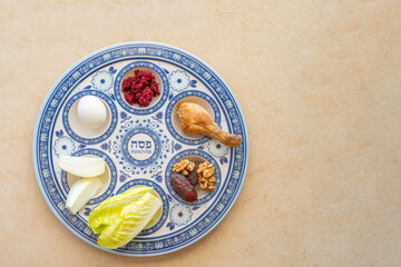 Traditional Seder Plate for Jewish holiday Pesach on marble background with copy space. Hebrew word...