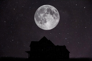 silhouette of a house with a moon in the background
