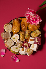 Still life of oriental sweets on a pink background