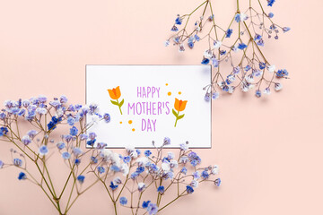 Greeting card with text HAPPY MOTHER'S DAY and beautiful gypsophila flowers on pink background
