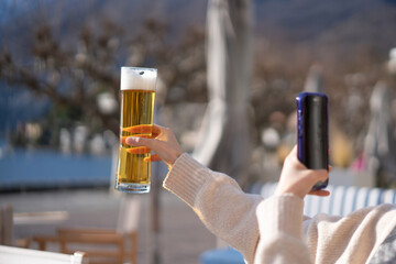 hand holding a glass of beer