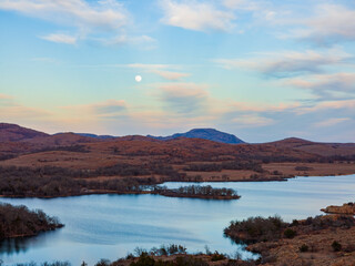 Fototapeta na wymiar Sunset landscape with a full moon in Wichita Mountains National Wildlife Refuge
