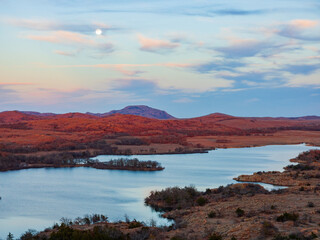 Fototapeta premium Sunset landscape with a full moon in Wichita Mountains National Wildlife Refuge