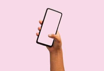 person holding a game console pink background