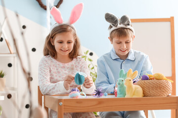 Little children with Easter decor at home