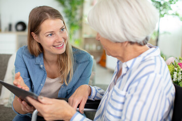 mother and daughter watch tablet