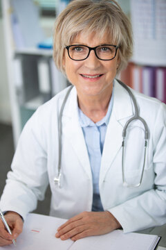 portrait of senior doctor at work looking at camera