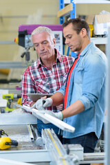 boss and worker together in a carpenters workshop