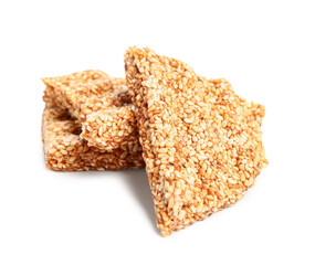 Pieces of tasty sesame kozinaki on white background