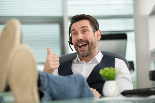 telemarketer man in a office showing ok sign