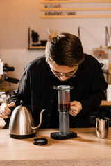 Barista sniff aeropress coffee aroma. Process of aeropress alternative method brewing coffee.
