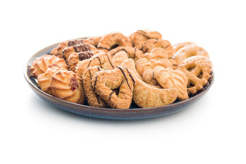 Assorted various cookies. Sweet biscuits on plate isolated on white background.