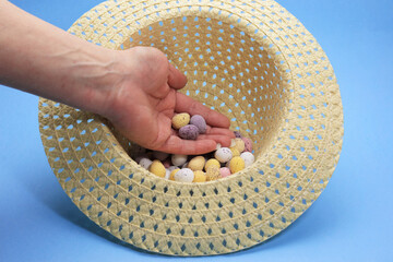 hand holding chocolate easter eggs in an easter bonnet