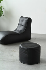 Black leather chaise longue on a white background.