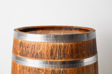 Wooden barrel on light background, closeup
