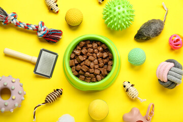 Fototapeta na wymiar Composition with different pet care accessories and wet food on yellow background