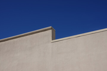 Fototapeta na wymiar Warehouse building roof edge and blue sky