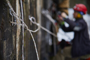 Rock climber climbing up a cliff
