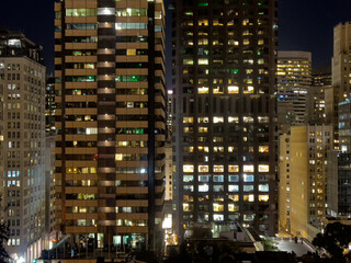 Fototapeta na wymiar High rise office buildings at night with lights on