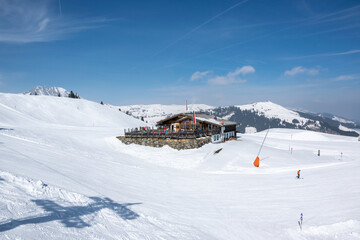 Fototapeta na wymiar Pass Thurn, Austria - Restaurant for skiers on a ski slope with snow in the mountains in winter.