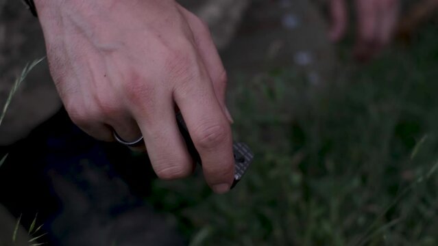 Man demonstrating penknife. Opening steel jackknife.