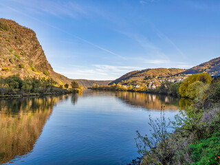 Fototapeta premium Moselle river and Zehl village in the afternoon during colourful autumn season in Cochem-Zell district, Germany