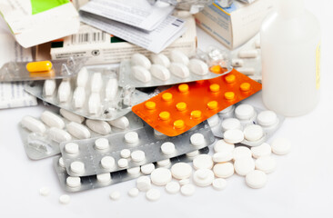 View of various pills and capsules on white background. Medical care concept