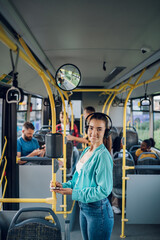 Woman riding in a bus and using a smartphone