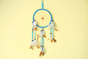 Beautiful dreamcatcher on beige background